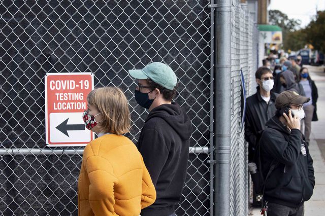People wait in line earlier this month at a COVID-19 testing location in Brooklyn's Borough Park.